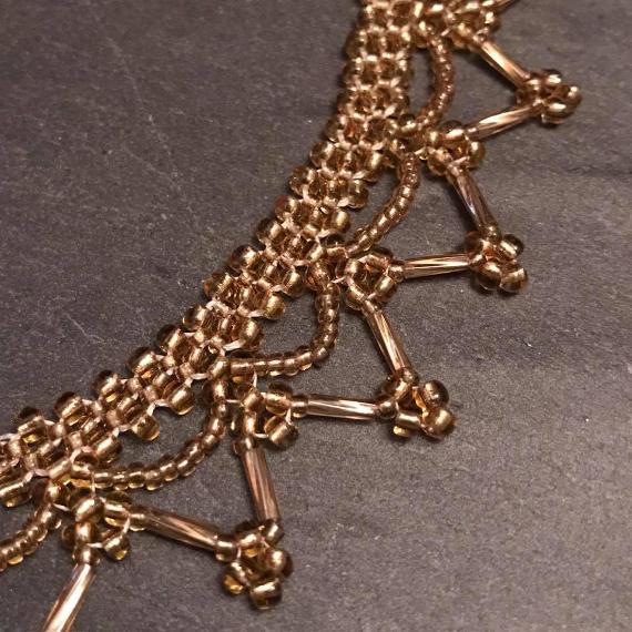 A close uo view of the gold lace necklace.