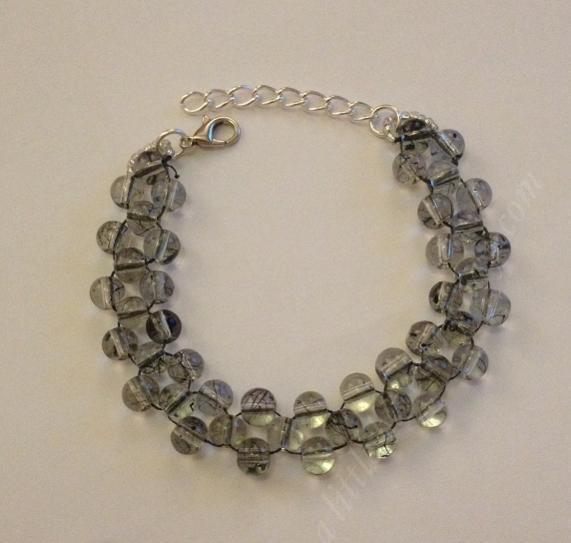 Right angle weave bracelet made from transparent grey round glass beads.