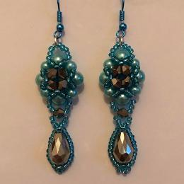 Hulton Abbey earrings made with two sizes of pale turquoise pearls on a white background.