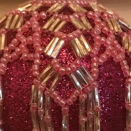 Close up of pink and silver Arabian Nights bauble on a fuchsia pink glitter Christmas tree ornament.