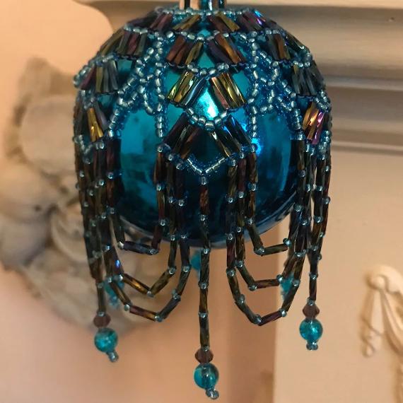 Turquoise Arabian Nights bauble. This is the same beadwork as shown in the main photo on a purple bauble yet the different coloured glass bauble makes it look totally different.
