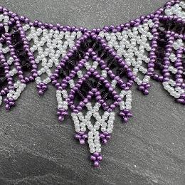 A close up view of a beaded lace necklace.