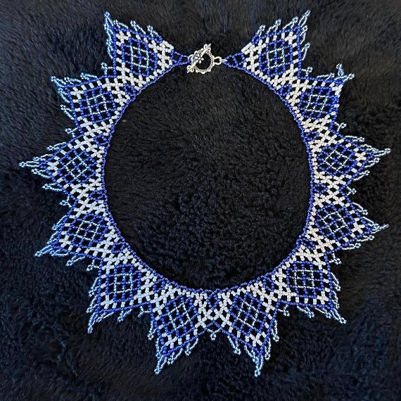 A lace collar necklace made from seed beads.