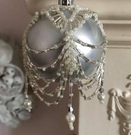 Ivory and silver beaded bauble cover on a matt silver ornamental ball.