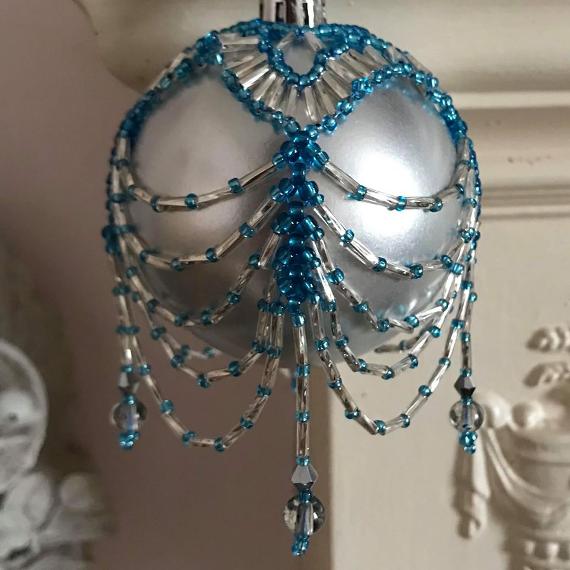 Swags and Tails beaded bauble in turquoise and silver beads on a matt silver glass ball ornament.