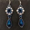 Photo of Hulton Abbey earrings made from white pearls and metallic blue crystals.