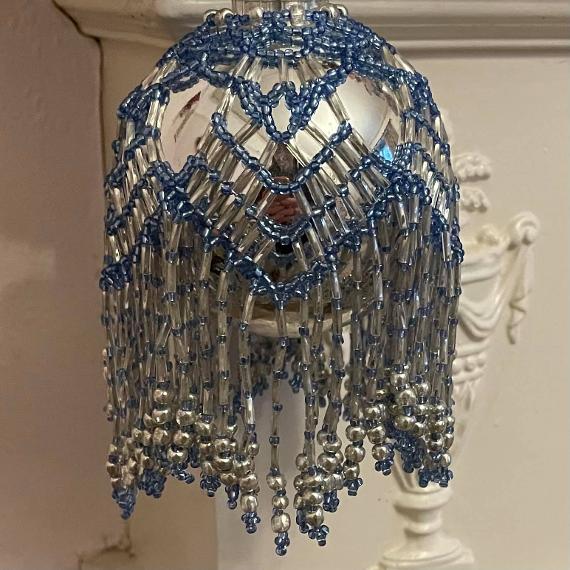 Chandelier bauble made with blue and silver beads on a silver bauble Christmas tree ornament.