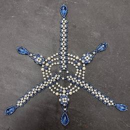 Blue and white bauble opened out flat.