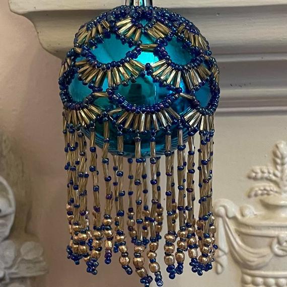 Shirley bauble. Blue and gold beads on a turquoise bauble.