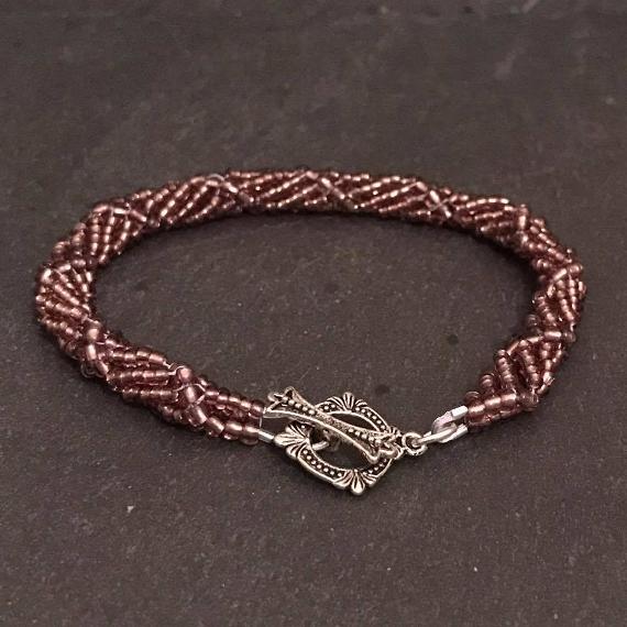 Spiral rope bracelet from the Purple Pendant Set pattern. It fastens with a ready made toggle clasp.