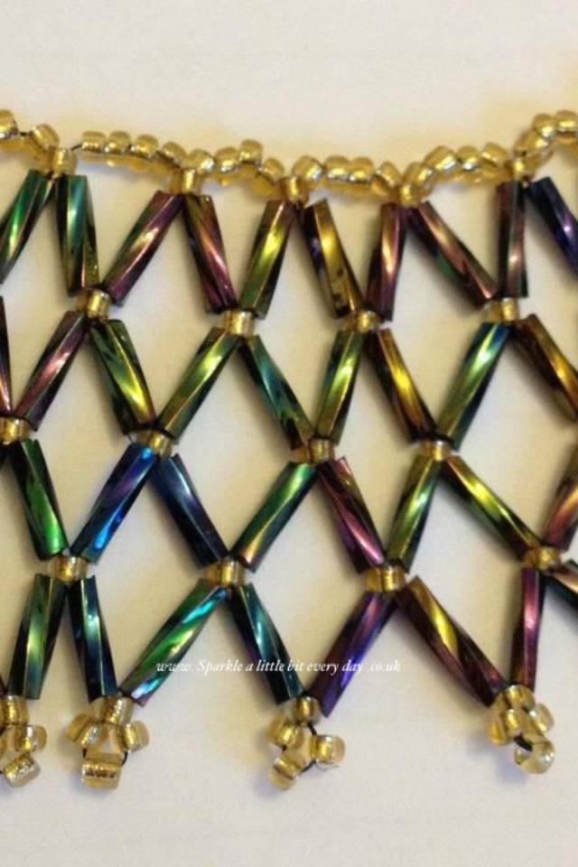 Close up of rainbow bugle bead netted necklace.