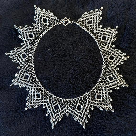 A lace collar necklace made from seed beads.