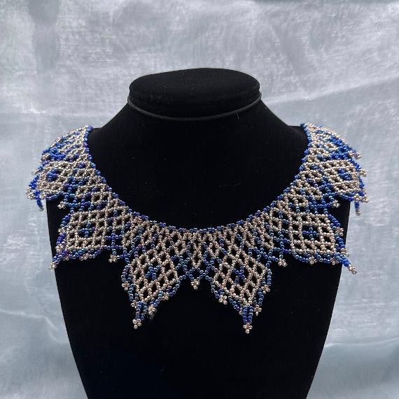 A lace collar necklace made from seed beads.