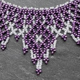 A close up view of a beaded lace necklace.