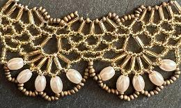 A close up view of a beaded lace necklace.