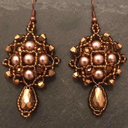Demeter earrings made form gold pearls and gold metallic crystals.