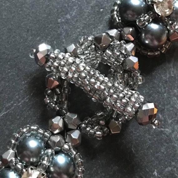 Close up view of the decorative beaded toggle clasp on the the thundercloud bracelet.
