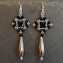 Tudor square earrings made from black bicone crystals and silver seed beads with a large silver teardrop bead.