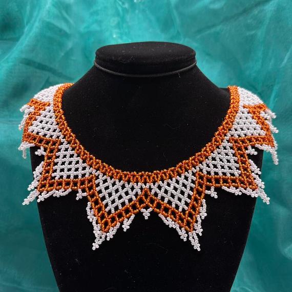 A lace collar necklace made from seed beads.