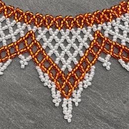 A close up view of a beaded lace necklace.