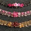 Photo of three necklaces with flowers on.