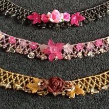 Three netted necklaces in pink, grey and gold beads with golden rutilated quartz semi-precious stones and decorated with various lucite flowers and polymer clay roses.