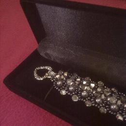 Grey version of the Lady Victoria bracelet in a black velvet jewellery box.