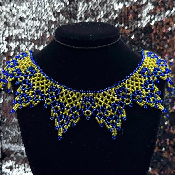 A lace collar necklace made from seed beads.