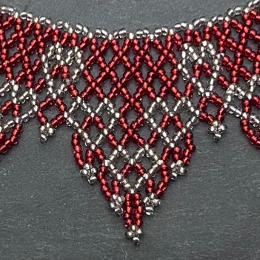 A close up view of a beaded lace necklace.