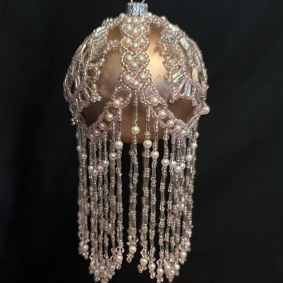 Gold bauble on a black background.