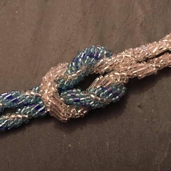 Knotted spirals bracelet. Close up photo of two spiral ropes formed into a knot to make become a bracelet.