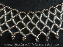 Netted necklace made with silver and grey seed beads.
