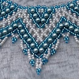 A close up view of a beaded lace necklace.
