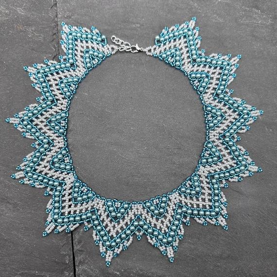 A lace collar necklace made from pearls and seed beads.