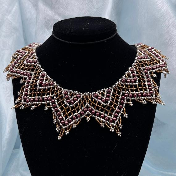 A lace collar necklace made from seed beads.