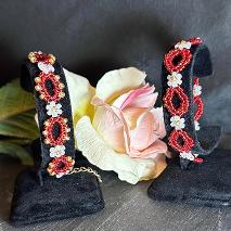 Two red bracelets with a rose