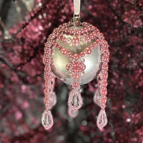 Pink pearl beads on a silver bauble Christmas tree ornament.