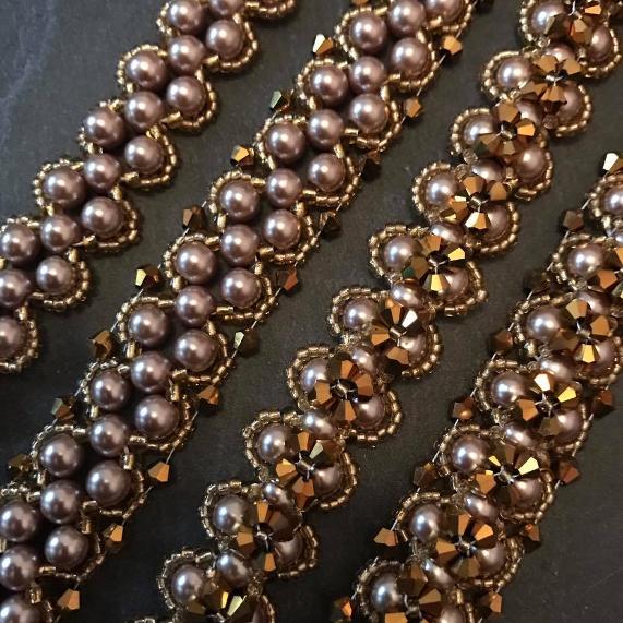 Close up of four versions of the Lady Victoria bracelet pattern made with gold pearls and crystals.