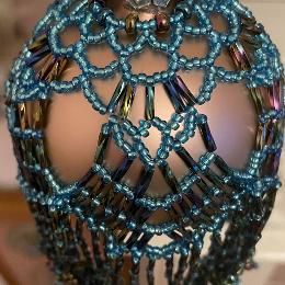 Chandelier bauble. Metallic rainbow and turquoise beads on a Christmas tree ornament.