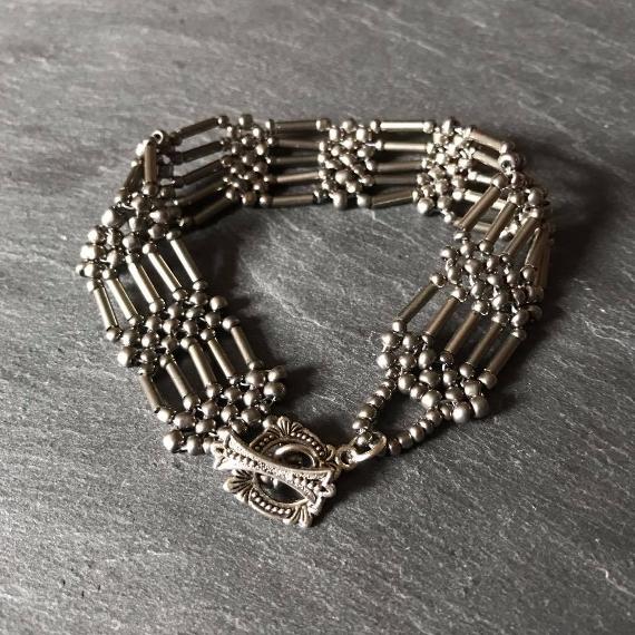 Steel Gate bracelet made from steel grey seed beads and bugles. This pattern is a modified version of right angle weave.