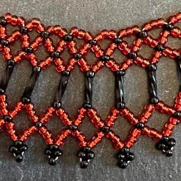 A close up photo of a beaded collar necklace.