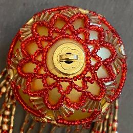 Shirley bauble. Red and gold beads on a gold Christmas tree ornament.