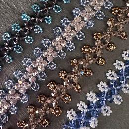 A close up photo of different colour variations of the crystal and seed bead bracelet.