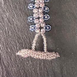 A close up view of a bead toggle clasp.