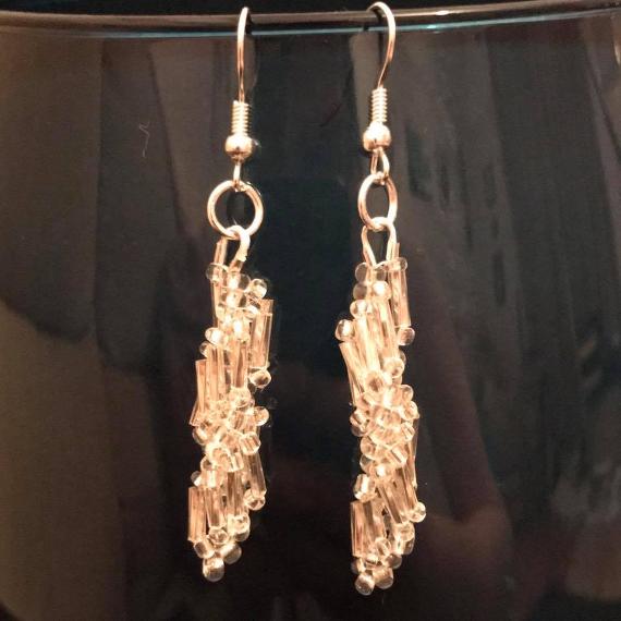 Earrings can be easily made using a short section of any stitch from the knotted spirals bracelet pattern. These earrings are made using silver bugle beads.