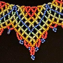 A close up view of a beaded lace necklace.
