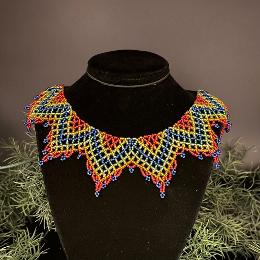 A photo of a lace necklace made from seed beads.