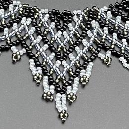 A close up photo of a beaded lace necklace.