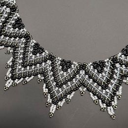 A close up view of a beaded lace necklace.
