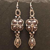 Grey earrings on grey slate.